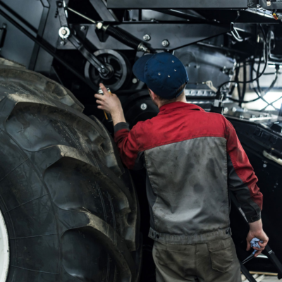 photo of mechanic wiping down agricultural equipment