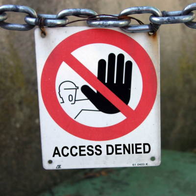 Signage that says "Access Denied". It has an image of a person yelling stop and one hand raised with their palm facing outward. 